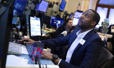 The combination of major macroeconomic and geopolitical issues will make it difficult for stocks to finish 2022 in positive territory. Pictured is trader Aaron Ford working on the New York Stock Exchange floor in New York City on March 11.