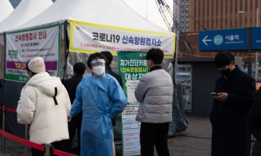 Members of the public wait in line at a temporary Covid-19 testing station set up outside Seoul Station on March 4.