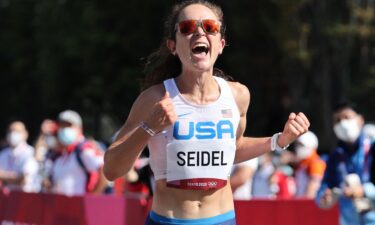 Molly Seidel celebrates as she crosses the finish line of the women's marathon at the Tokyo 2020 Olympic Games in Sapporo on August 2021.