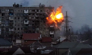 An explosion is seen in an apartment building after Russian's army tank fires in Mariupol