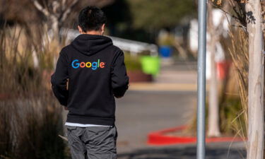 A pedestrian wearing a Google branded hoodie walks on the Google campus at the company's headquarters in Mountain View