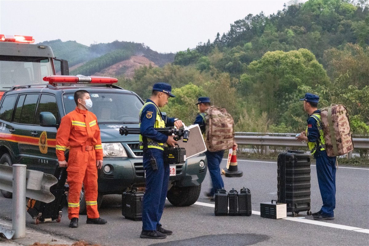 <i>Jiang Hui/VCG/Getty Images</i><br/>Rescuers head to the site of a plane crash on March 21 in China's Tengxian County.