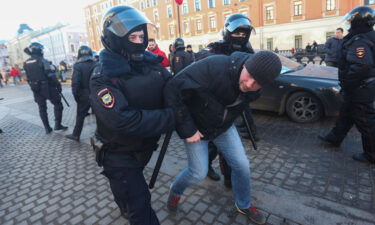 Police Officers detain a protestor during a demonstration against the Russian military operation in Ukraine.