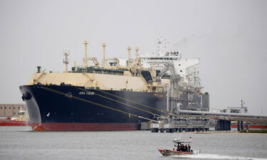 A US Coast Guard boat moves past the Asia Vision LNG carrier ship docked at a terminal in Sabine Pass