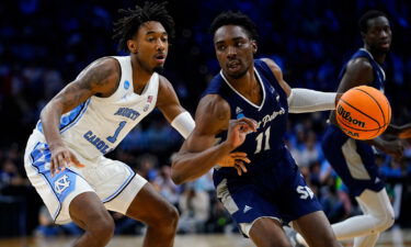 St. Peter's KC Ndefo tries to get around North Carolina's Leaky Black during the first half of a college basketball game in the Elite 8 round of the NCAA tournament.