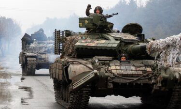 Ukrainian servicemen ride on tanks towards the front line with Russian forces in the Lugansk region of Ukraine in February.