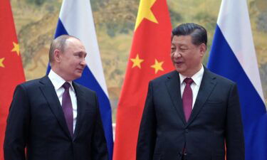 Russian President Vladimir Putin (L) and Chinese President Xi Jinping pose for a photograph during their meeting in Beijing