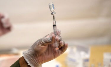 A healthcare worker prepares a syringe with a vial of the J&J/Janssen Covid-19 vaccine at a temporary vaccination site at Grand Central Terminal train station on May 12