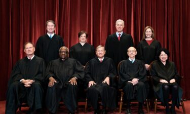 Members of the Supreme Court pose for a group photo at the Supreme Court in Washington