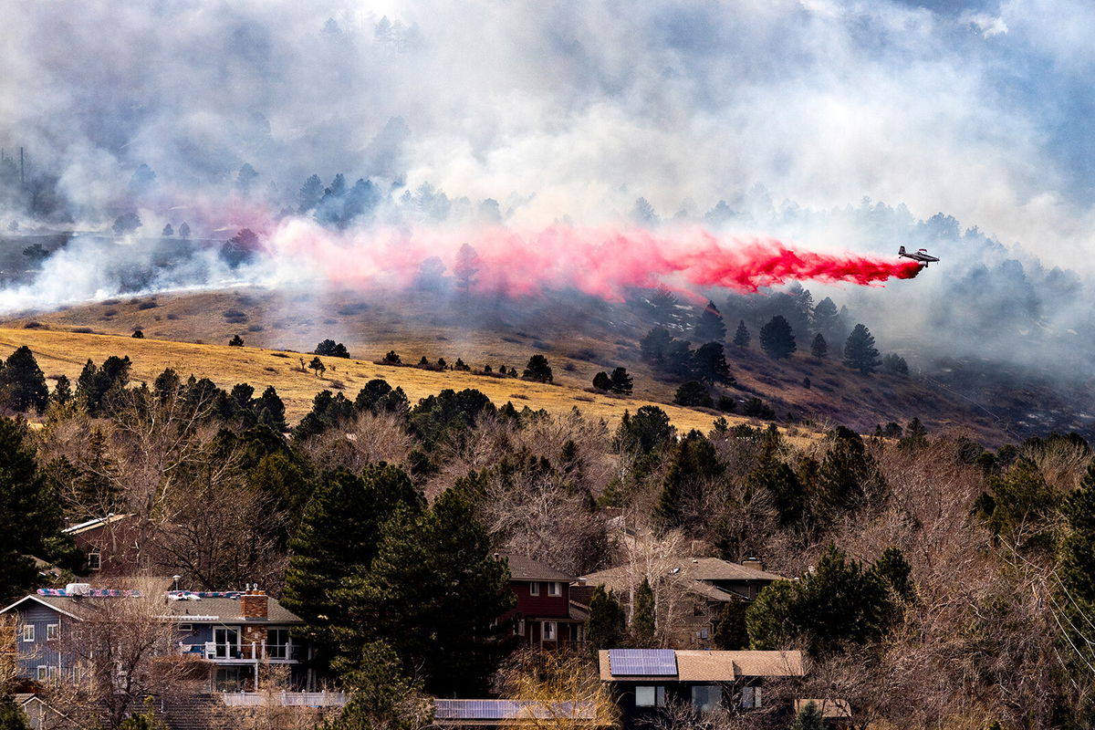 <i>Michael Ciaglo/Getty Images</i><br/>An air tanker drops slurry