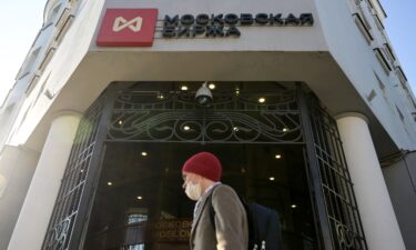 A man walks past Moscow's stock market building in downtown Moscow on February 28. Russia's stock market opened for the first time in a month on March 24