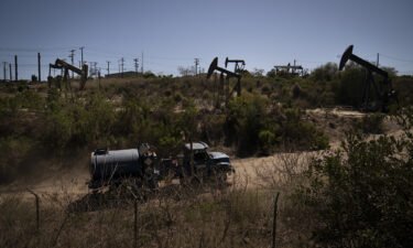 A truck drives past pump jacks operating at the Inglewood Oil Field Thursday