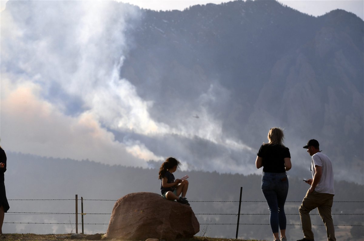 <i>Helen H. Richardson/Denver Post/AP</i><br/>People watch as the NCAR Fire near Boulder burns in the foothills south of the National Center for Atmospheric Research on Saturday.