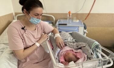 Khrystyna Pavluchenko tends to her newborn daughter