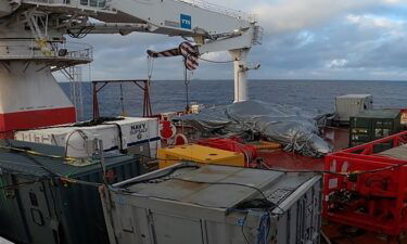 US Navy service members recover the wreckage of a military aircraft from the bottom of the South China Sea on March 2.