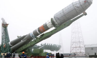 A Soyuz-2.1b rocket booster with a Fregat upper stage carrying British OneWeb satellites is being installed on a launch pad at the Baikonur Cosmodrome in Kazakhstan.