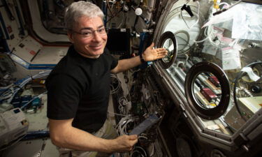 NASA astronaut and Expedition 66 Flight Engineer Mark Vande Hei sets up hardware on the International Space Station.