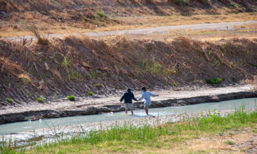 The Biden administration ends a Trump-era border policy for unaccompanied migrant children. Two children here cross the Rio Grande in Juarez