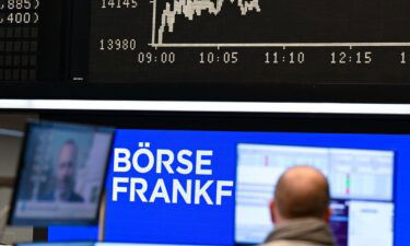 While a stock trader watches his monitor on the floor of the Frankfurt Stock Exchange