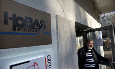 Novaya Gazeta editor Dmitry Muratov is seen at the entrance to the office of the Novaya Gazeta newspaper in Moscow in October 2021. The Novaya Gazeta is suspending publication until the end of the war in Ukraine.