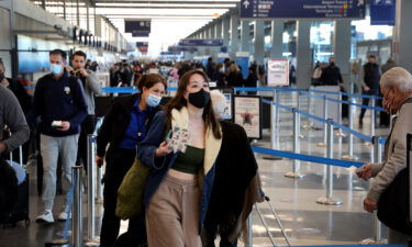 People go through TSA screening as they catch flights at O'Hare International Airport on March 11.