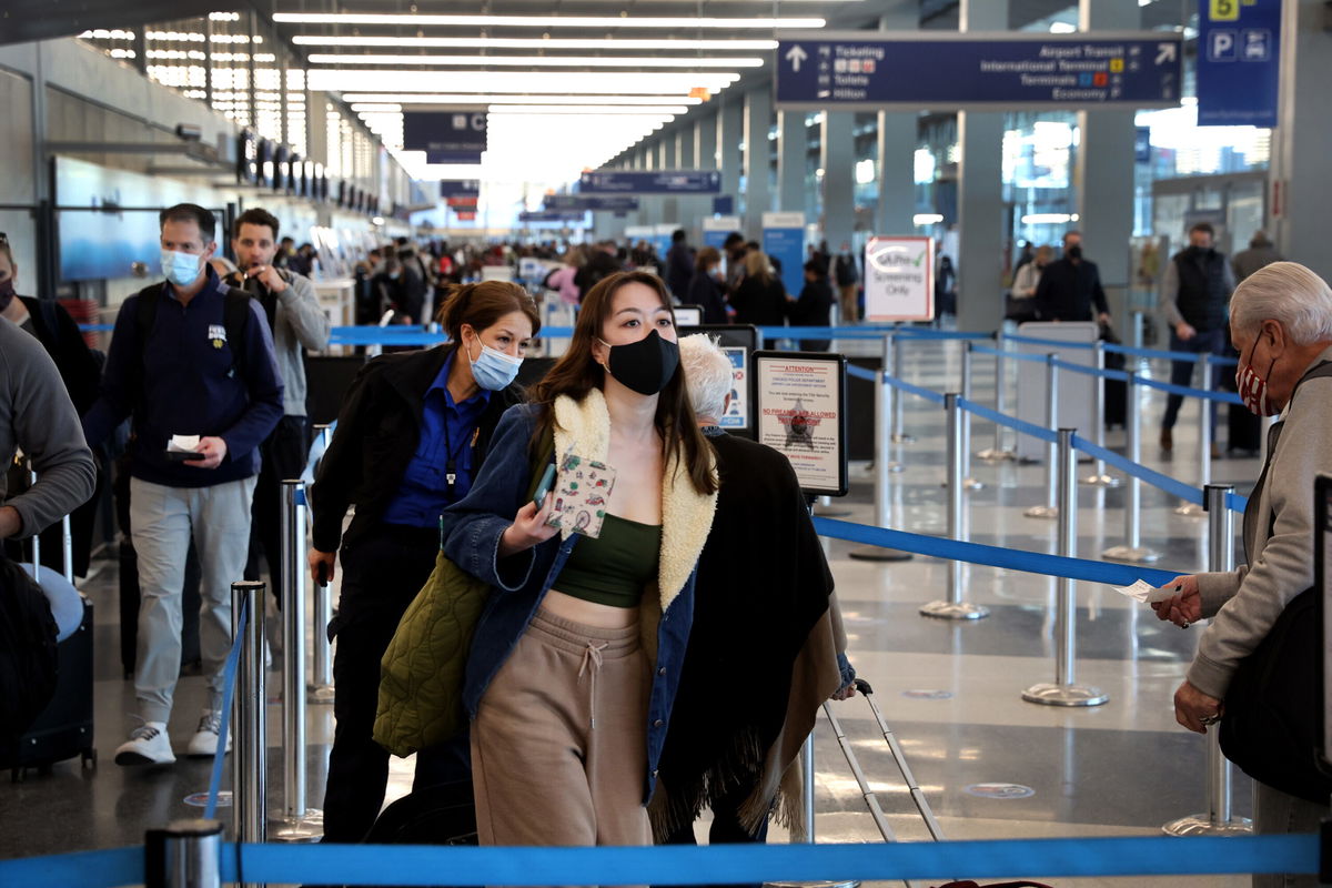 <i>Scott Olson/Getty Images</i><br/>People go through TSA screening as they catch flights at O'Hare International Airport on March 11.