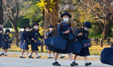 Elementary school students walk home after their lessons in Tokyo