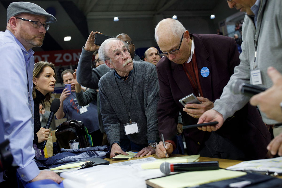 <i>Tom Brenner/Getty Images North America/Getty Images</i><br/>Officials from the 68th caucus precinct overlook the results of the first referendum count during a caucus event on February 3