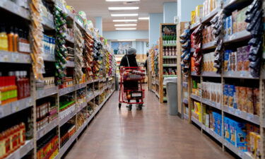 A shopper walks through a grocery store in Washington