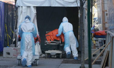 Bodies are moved to a refrigerator truck serving as a temporary morgue in New York. The global Covid-19 death toll surpassed 6 million on March 7