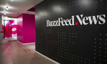 A BuzzFeed News logo adorns a wall inside BuzzFeed's headquarters in New York City in December 2018. BuzzFeed News announced on March 22 that its editor in chief is stepping down and the company is offering buyouts.