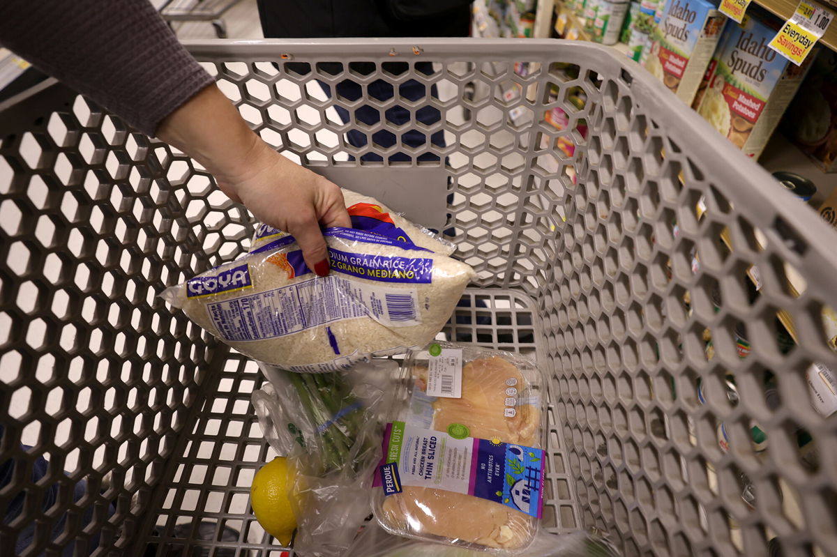 <i>Michael Loccisano/Getty Images North America/Getty Images</i><br/>An Instacart shoppers places items in a cart at a ShopRite on January 08
