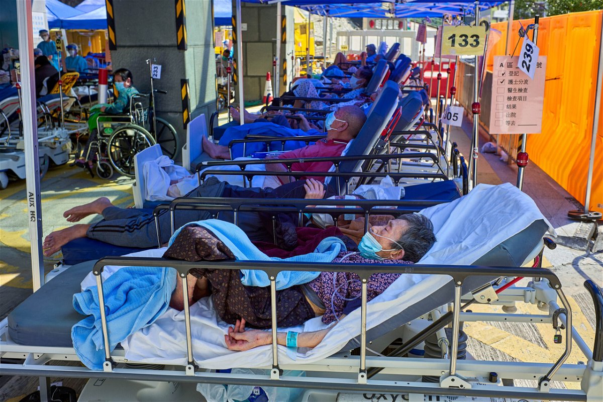 <i>Emmanuel Serna/SOPA Images/LightRocket/Getty Images</i><br/>Covid-19 patients seen laying on beds outside the Caritas Medical Center in Hong Kong.