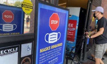 People shop at a grocery store enforcing the wearing of masks in Los Angeles on July 23