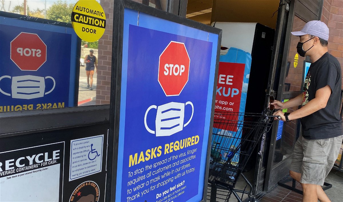 <i>CHRIS DELMAS/AFP/AFP via Getty Images</i><br/>People shop at a grocery store enforcing the wearing of masks in Los Angeles on July 23