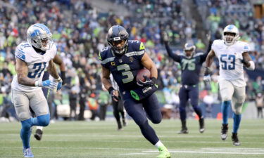 Russell Wilson runs the ball against the Detroit Lions during the fourth quarter of a game on January 2