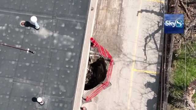 <i>KCCI</i><br/>A large hole has opened up in the alley behind the Hy-Vee at the Uptown Shopping Center at 42nd Street and University. According to the property manager