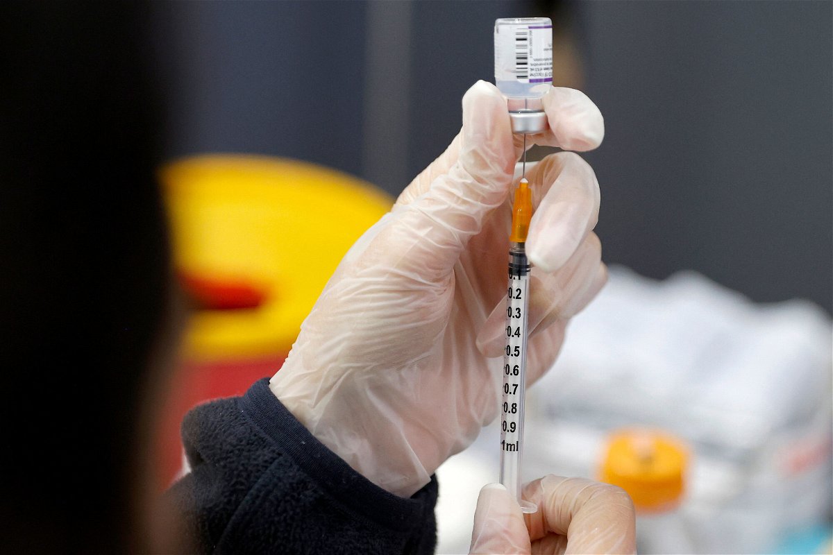 <i>Jack Guez/AFP/Getty Images</i><br/>A medic prepares a dose of the Pfizer-BioNTech vaccine against the coronavirus at a private nursing home.