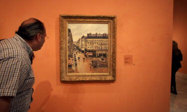 A Supreme Court ruling aids a family seeking the return of a painting confiscated by Nazis. An unidentified visitor looks at the Impressionist painting by Camille Pissarro called the "Rue Saint Honoré