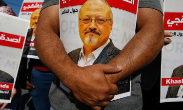 People hold posters of slain Saudi journalist Jamal Khashoggi near the Saudi Arabian consulate in Istanbul