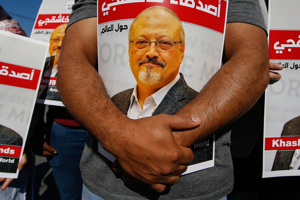 <i>Emrah Gurel/AP</i><br/>People hold posters of slain Saudi journalist Jamal Khashoggi near the Saudi Arabian consulate in Istanbul
