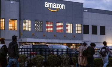 People arrive for work at the Amazon distribution center in the Staten Island borough of New York