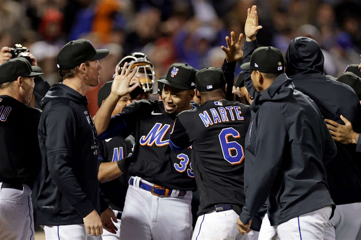 <i>Adam Hunger/AP</i><br/>Pitcher Edwin Díaz celebrates with teammates after the Mets threw a combined no-hitter to defeat the Philadelphia Phillies 3-0 in New York.