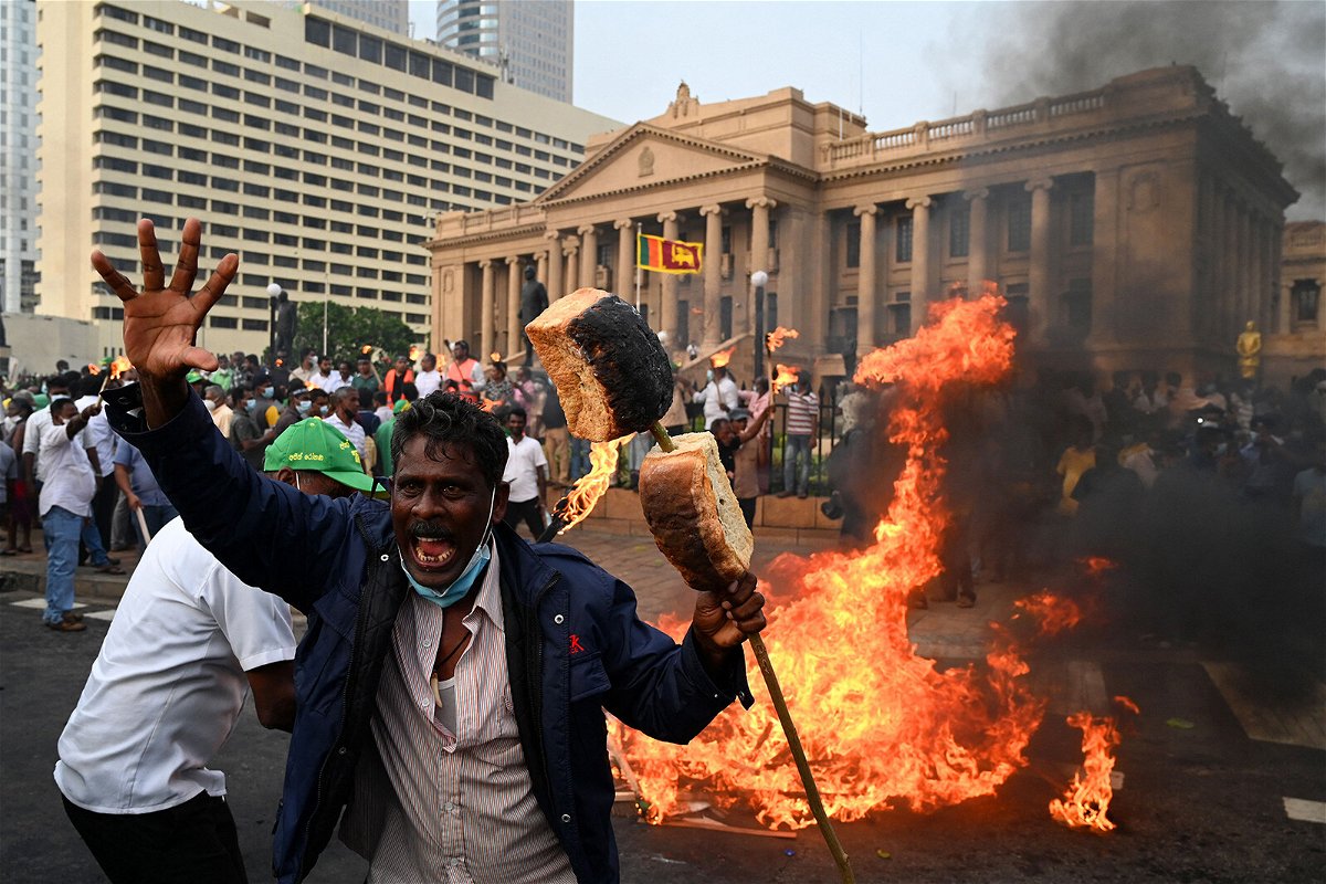 <i>Ishara S. Kodikara/AFP/Getty Images)</i><br/>An opposition activist shouts slogans holding up bread as he protests along with others against rising living costs