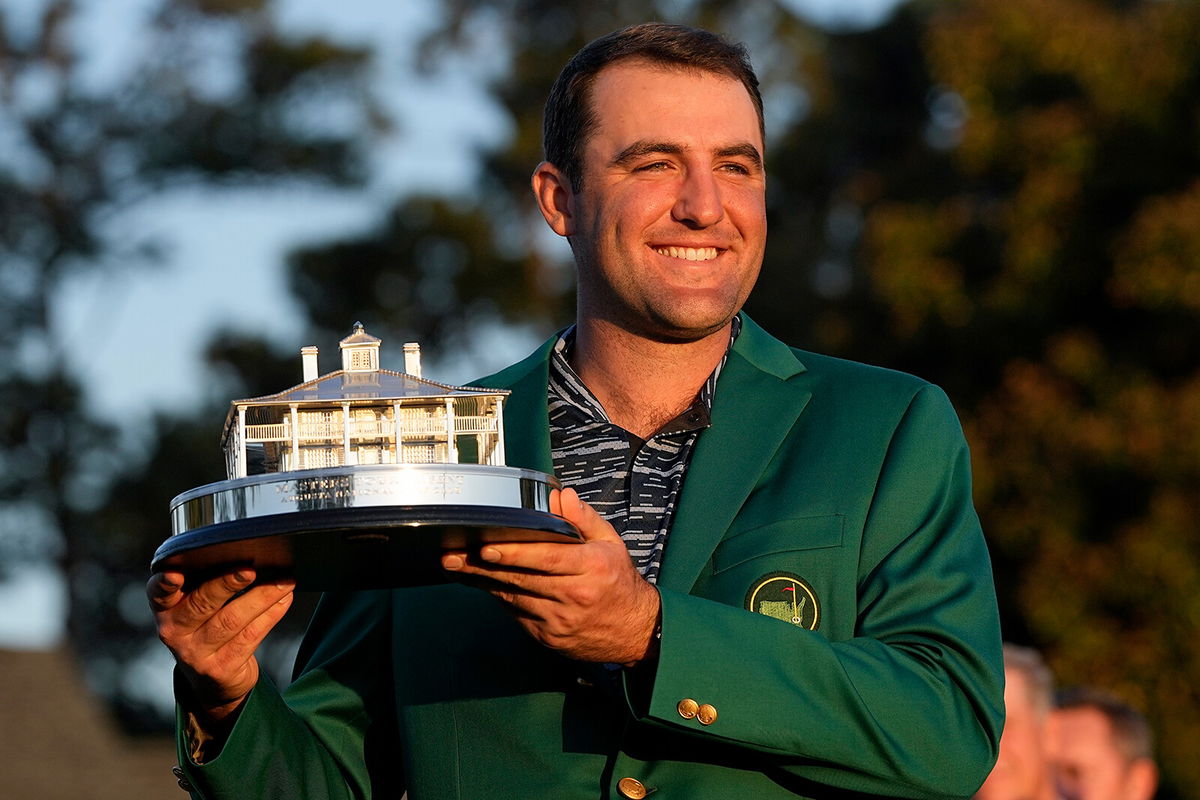 <i>David J. Phillip/AP</i><br/>Scottie Scheffler holds the championship trophy after winning the 86th Masters on April 10.