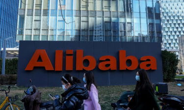 People walk past the offices of Chinese e-commerce firm Alibaba in Beijing