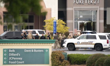 Law enforcement gather outside Columbiana Centre mall Saturday.