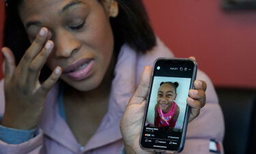 Brittany Tichenor-Cox holds a photo of her daughter