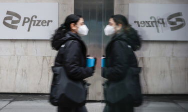 A woman walks by Pfizer headquarters on March 1. In New York. Investors are worried that the risks of a recession are rising in the United States. In Europe