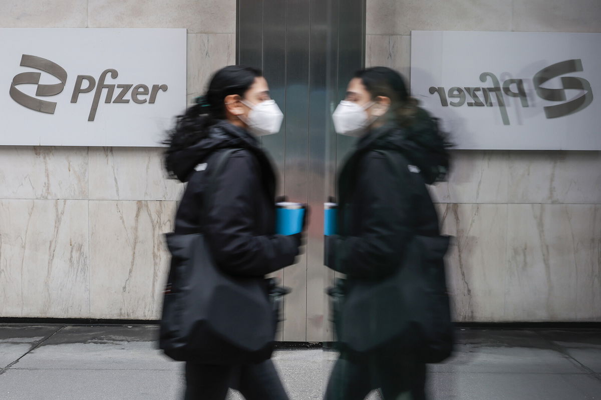 <i>Eduardo MunozAlvarez/VIEWpress/Getty Images</i><br/>A woman walks by Pfizer headquarters on March 1. In New York. Investors are worried that the risks of a recession are rising in the United States. In Europe